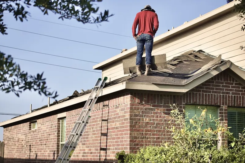 Professional roofer working on a residential roof in Conewago